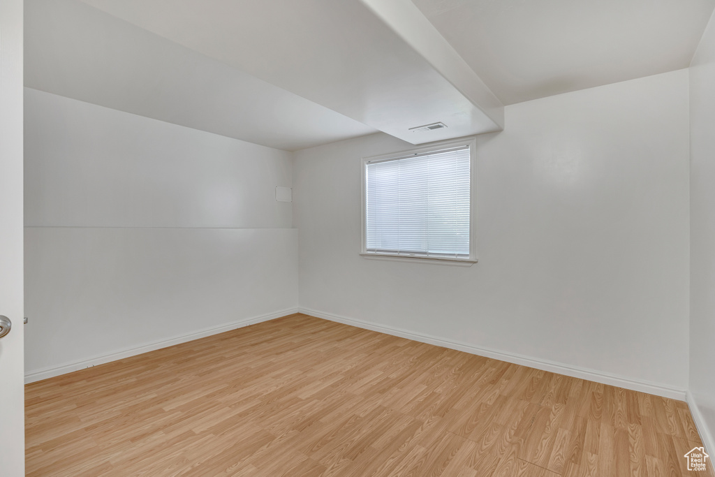 Unfurnished room featuring wood finished floors and baseboards