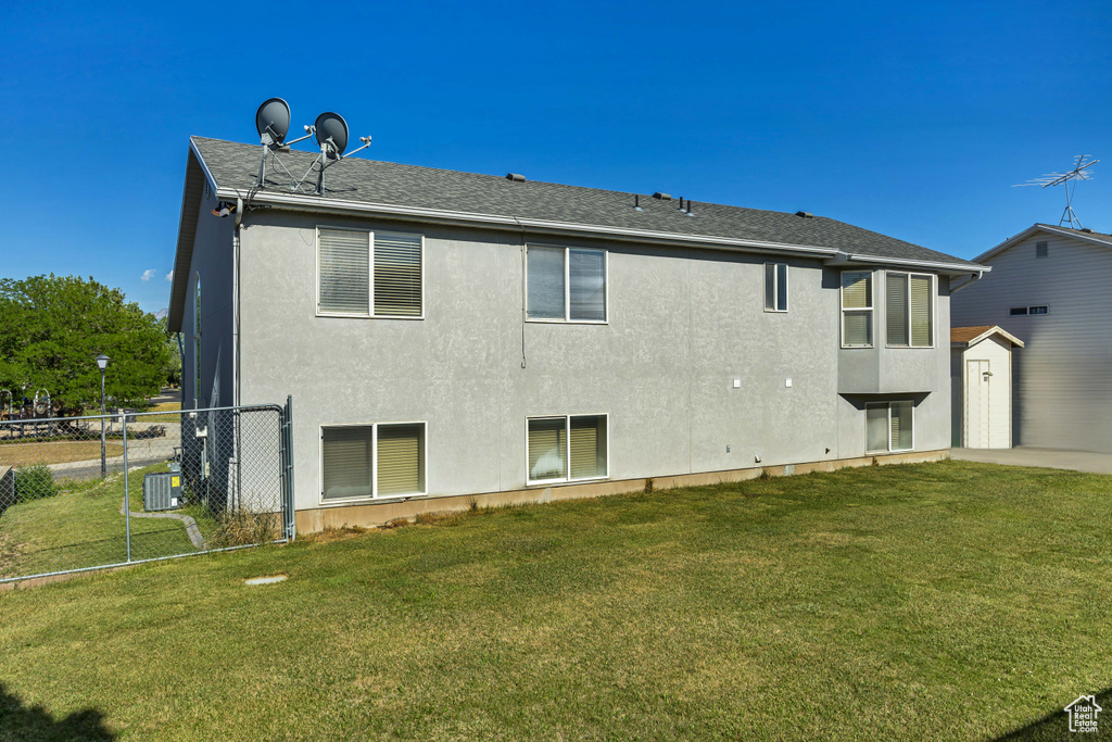 Rear view of house with stucco siding and central air condition unit