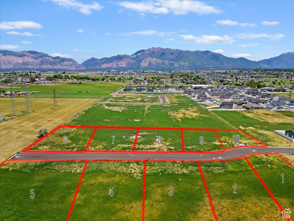 Aerial view of property and surrounding area featuring property boundaries highlighted and mountains