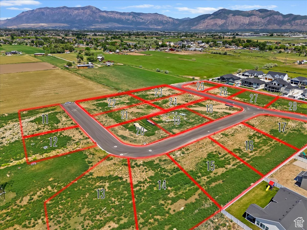 Aerial view of property and surrounding area featuring mountains and property boundaries highlighted