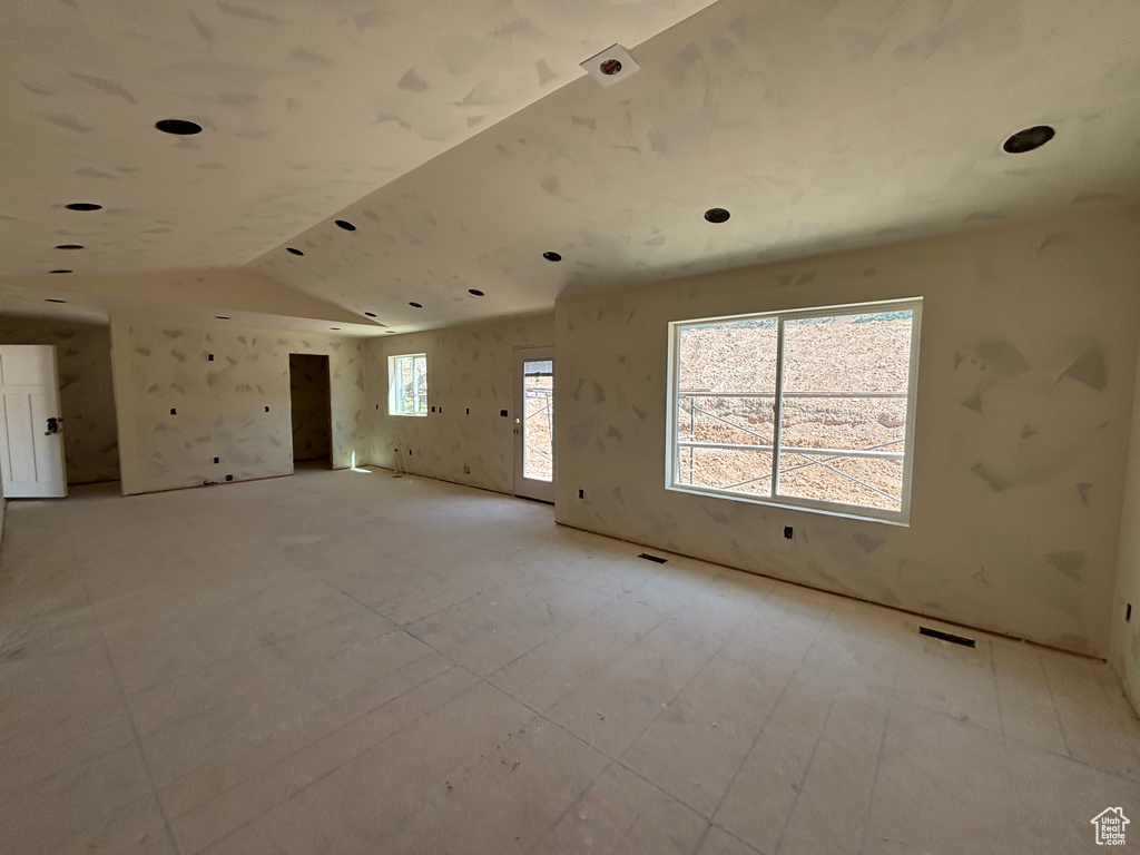 Spare room featuring vaulted ceiling