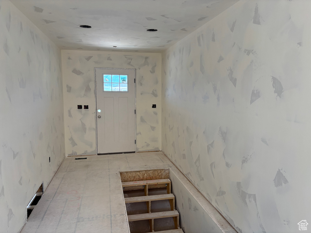 Entryway featuring wallpapered walls