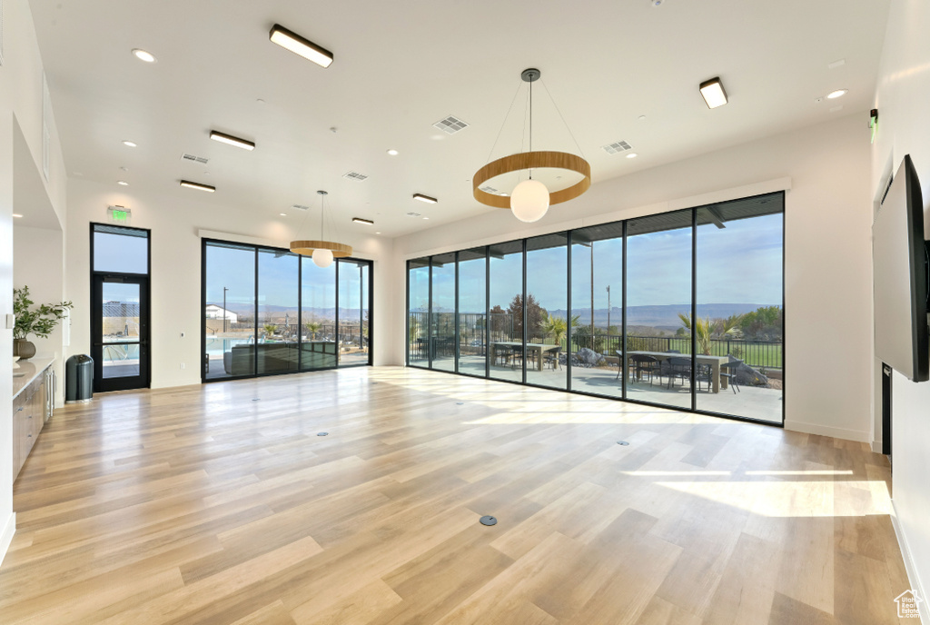 Spare room with light wood-style flooring, plenty of natural light, and recessed lighting