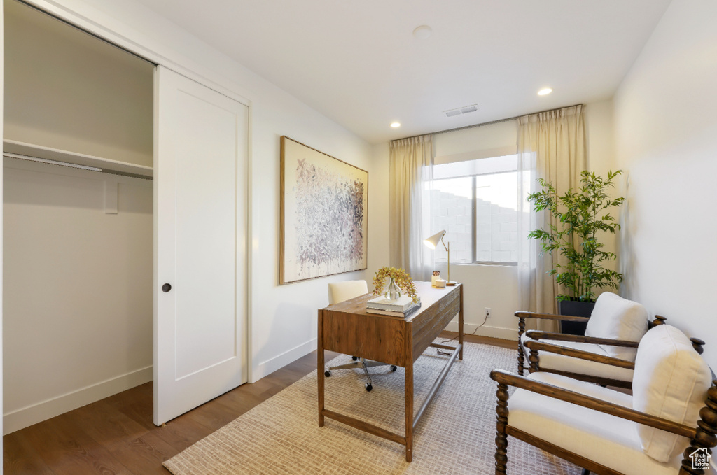 Office space featuring baseboards, wood finished floors, and recessed lighting