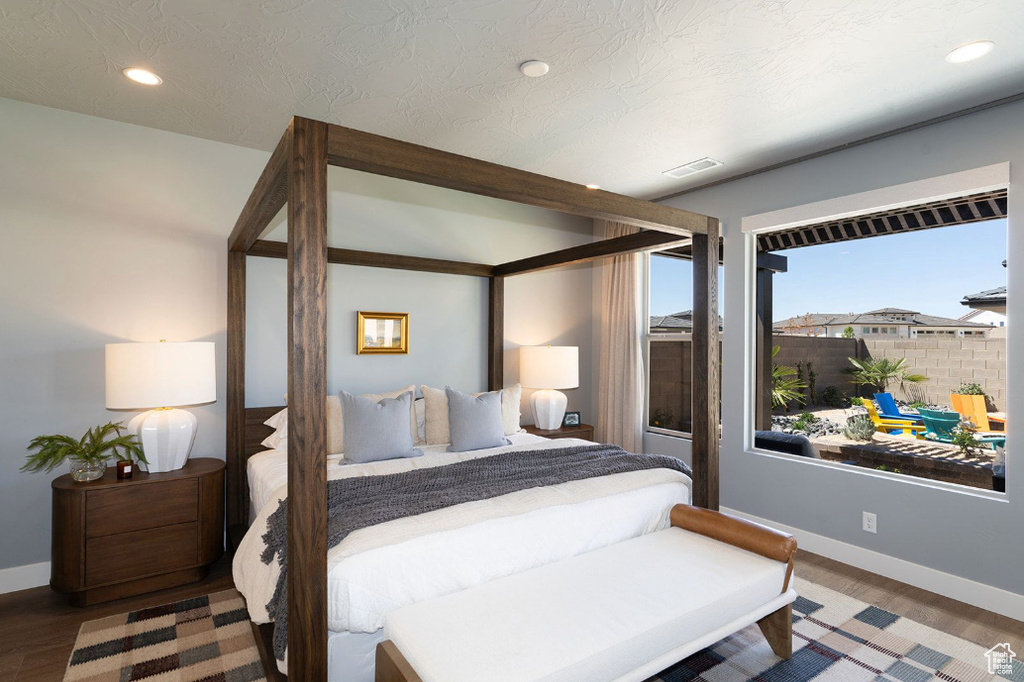 Bedroom with baseboards, recessed lighting, and wood finished floors