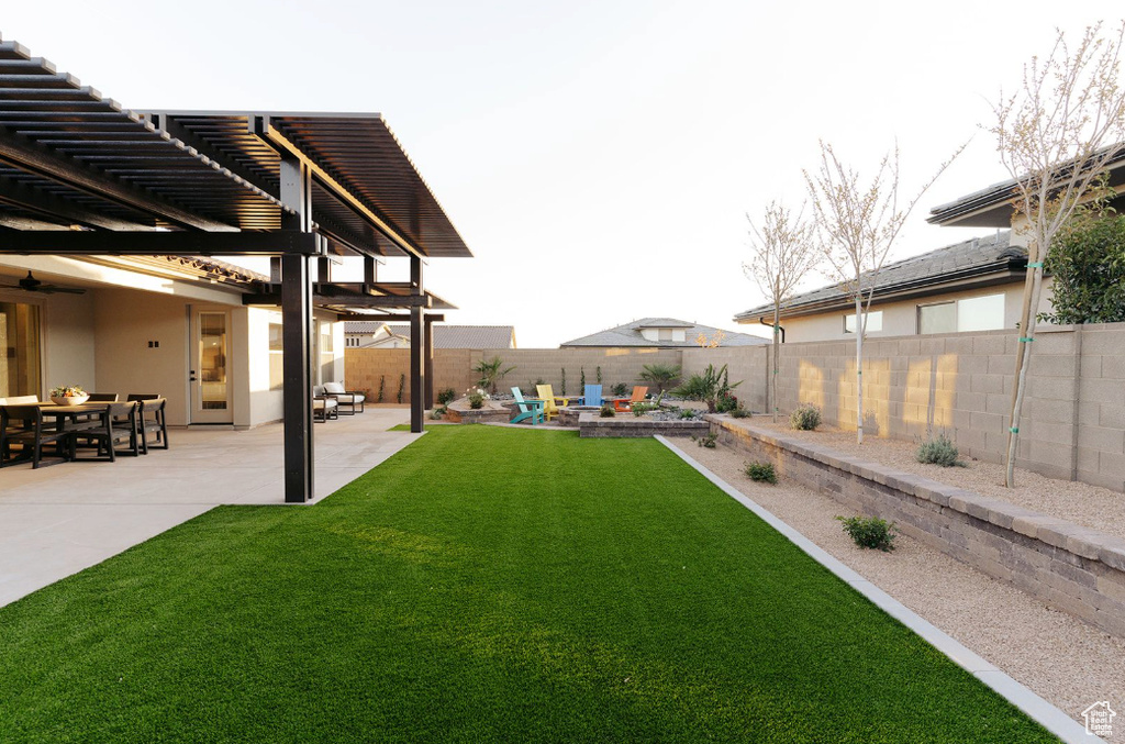 View of yard featuring a patio, a pergola, and a ceiling fan