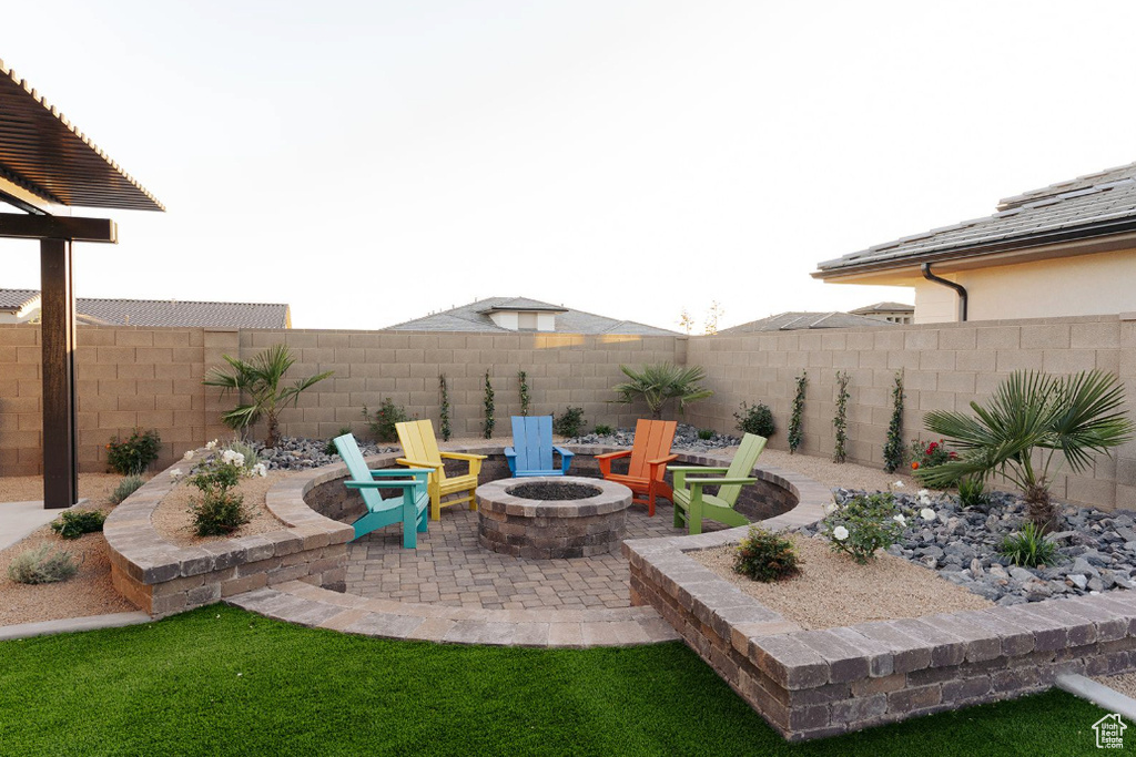 Fenced yard featuring a fire pit and a patio area