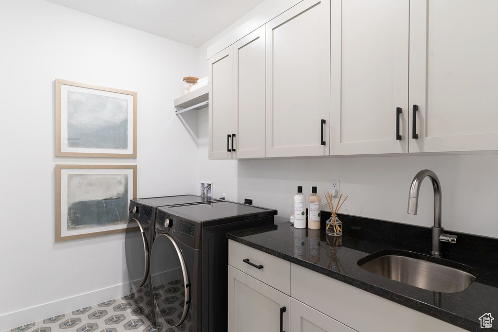 Laundry room with cabinet space, washer and clothes dryer, and baseboards