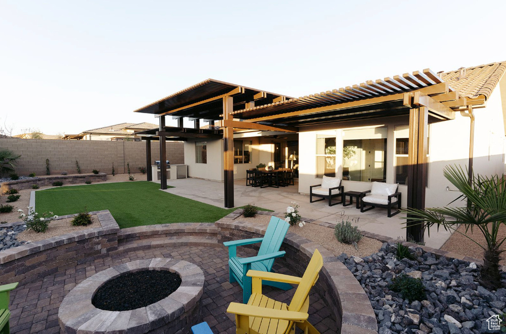 View of patio featuring an outdoor fire pit and a pergola