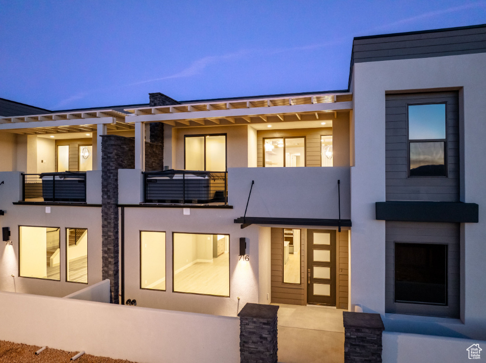 View of front of property featuring stucco siding and stone siding