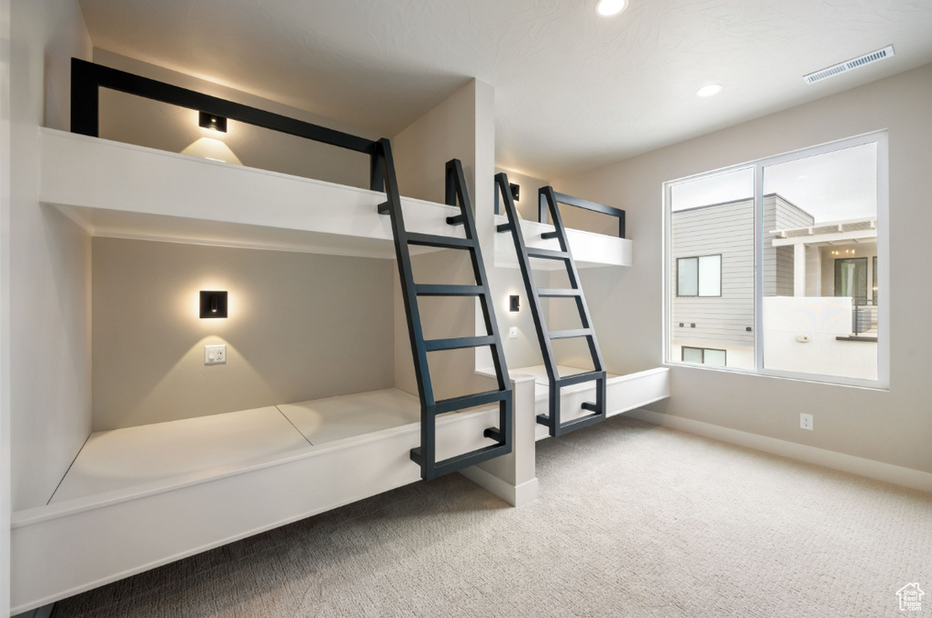 Unfurnished bedroom featuring carpet floors, baseboards, and recessed lighting