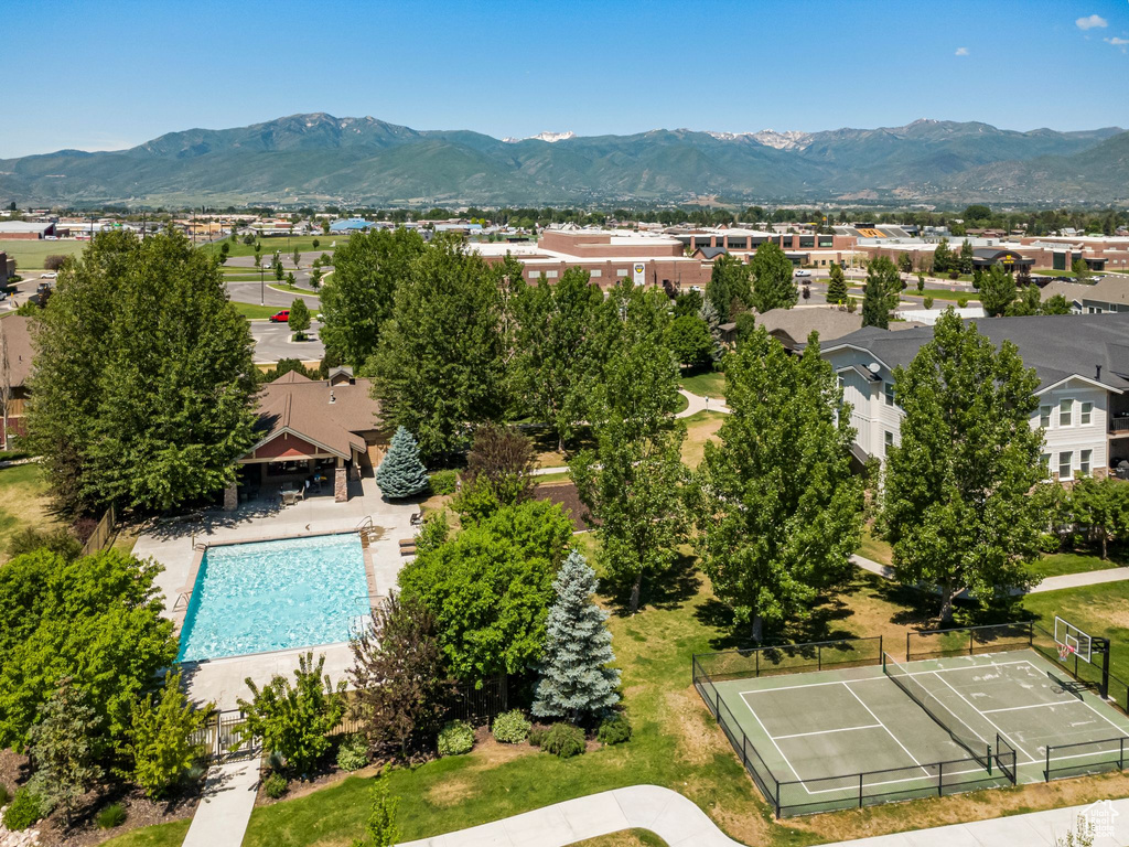 Aerial perspective of suburban area featuring mountains and a pool area