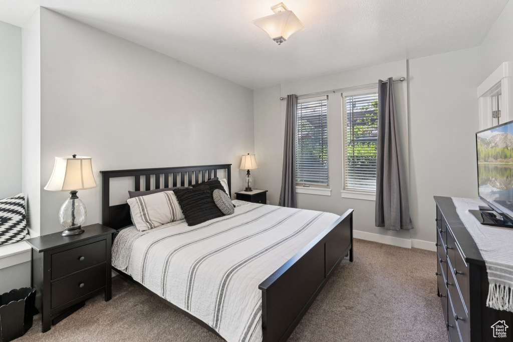 Bedroom with light carpet and baseboards
