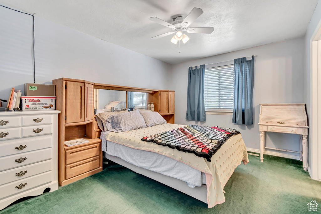 Bedroom with carpet, ceiling fan, and baseboards