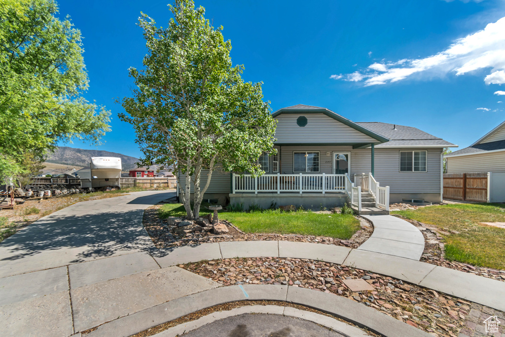 Bungalow-style house with covered porch and concrete driveway