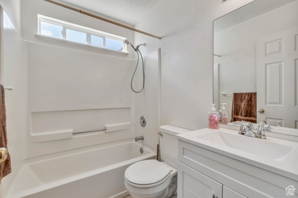 Bathroom with vanity, toilet, and shower / bathtub combination