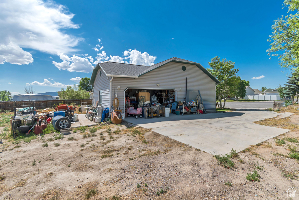 View of side of home featuring an outbuilding and driveway