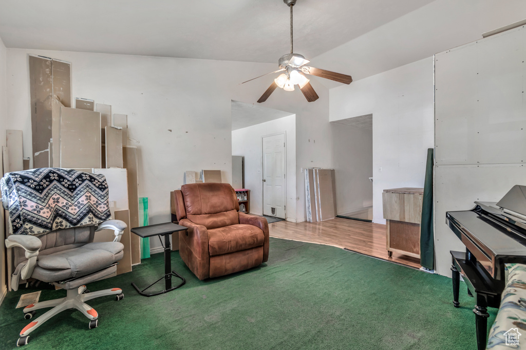 Sitting room with carpet flooring, a ceiling fan, and lofted ceiling
