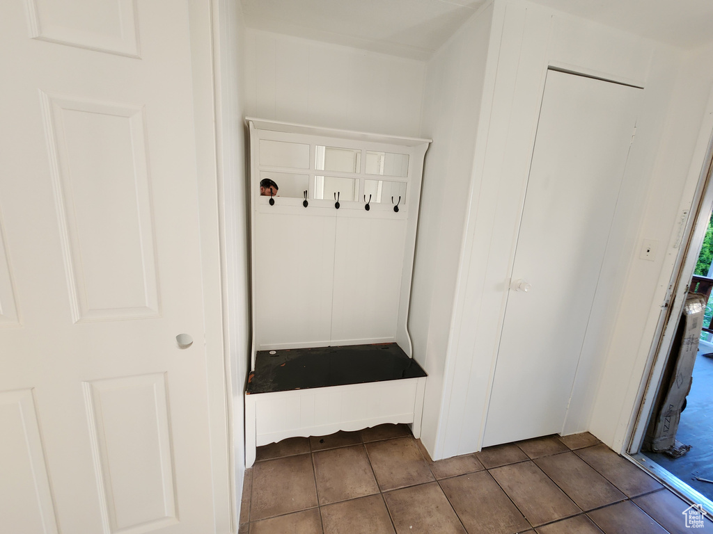 Mudroom with dark tile patterned floors