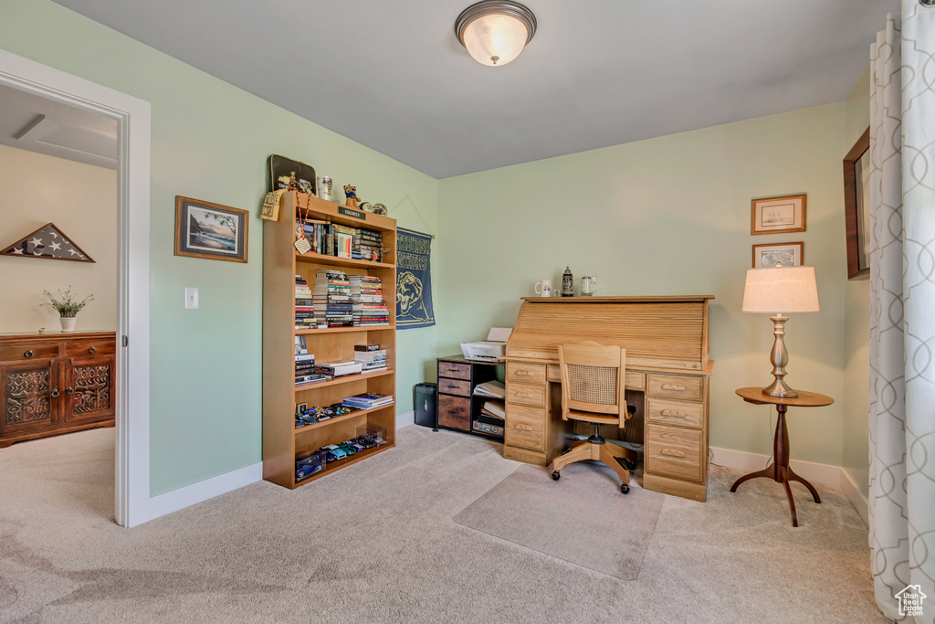 Carpeted office space featuring baseboards