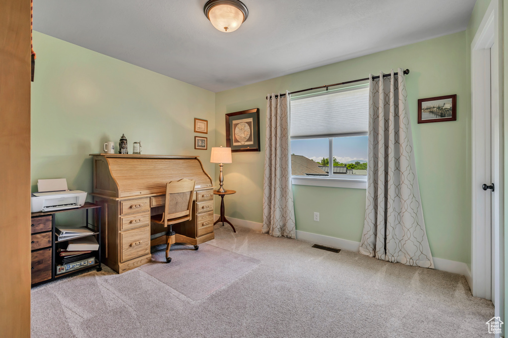 Carpeted home office with baseboards