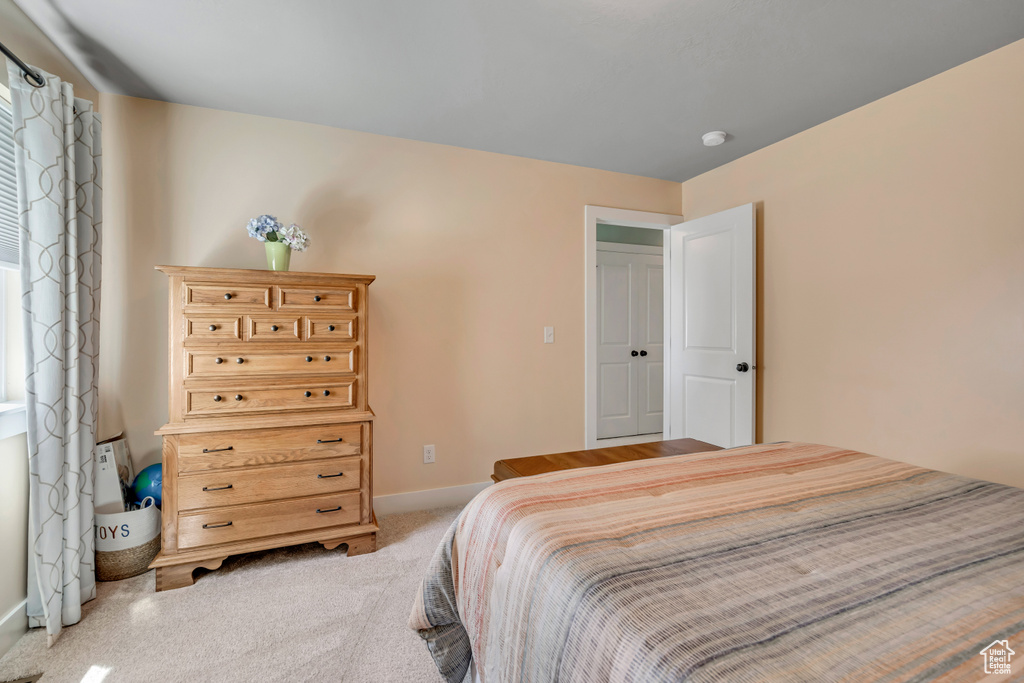 Carpeted bedroom featuring baseboards