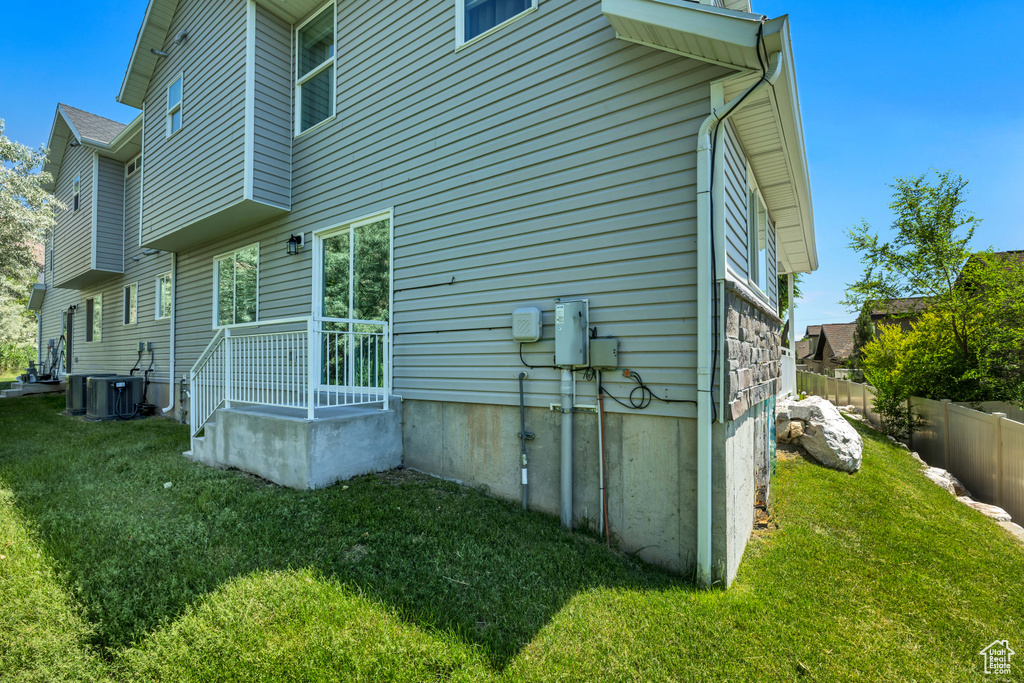 Rear view of property with central AC unit