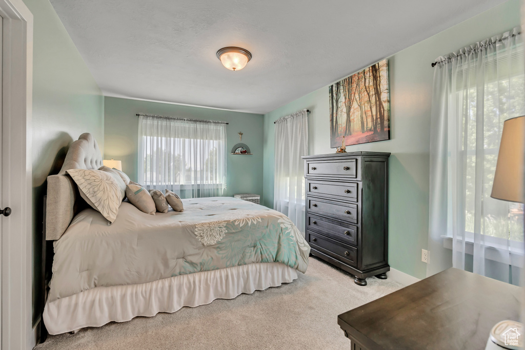 Bedroom featuring light carpet