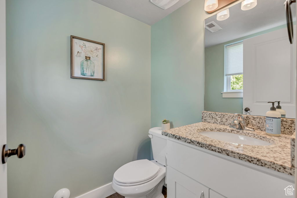 Half bathroom with toilet and vanity