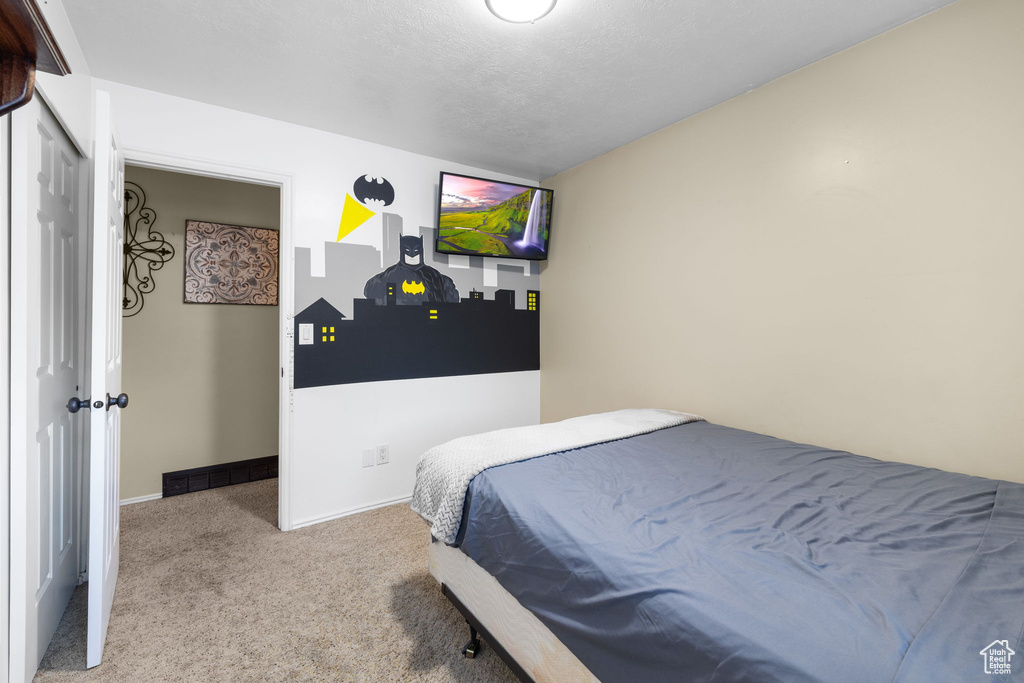 Bedroom with carpet flooring and baseboards