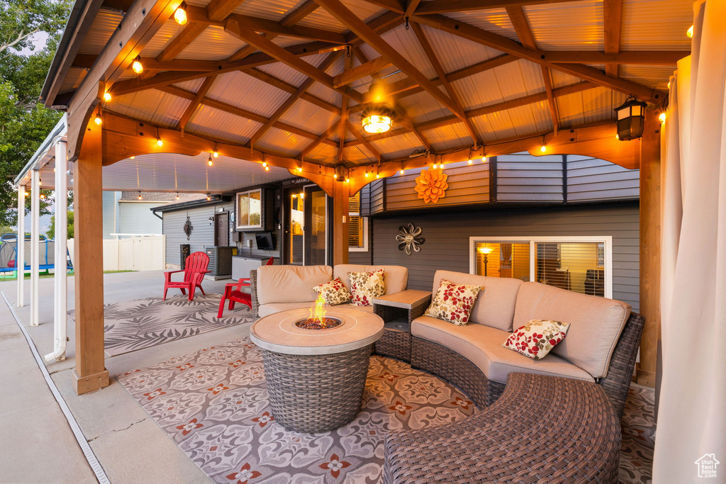 View of patio / terrace with a gazebo and an outdoor living space with a fire pit