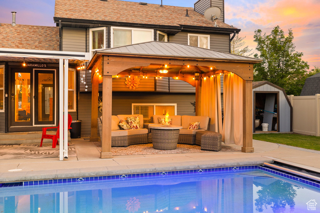 Outdoor pool featuring outdoor lounge area, a gazebo, and a patio