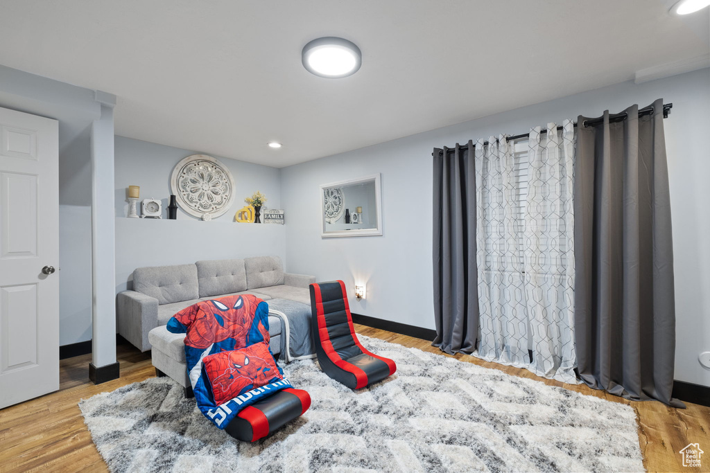 Bedroom with recessed lighting, wood finished floors, and baseboards