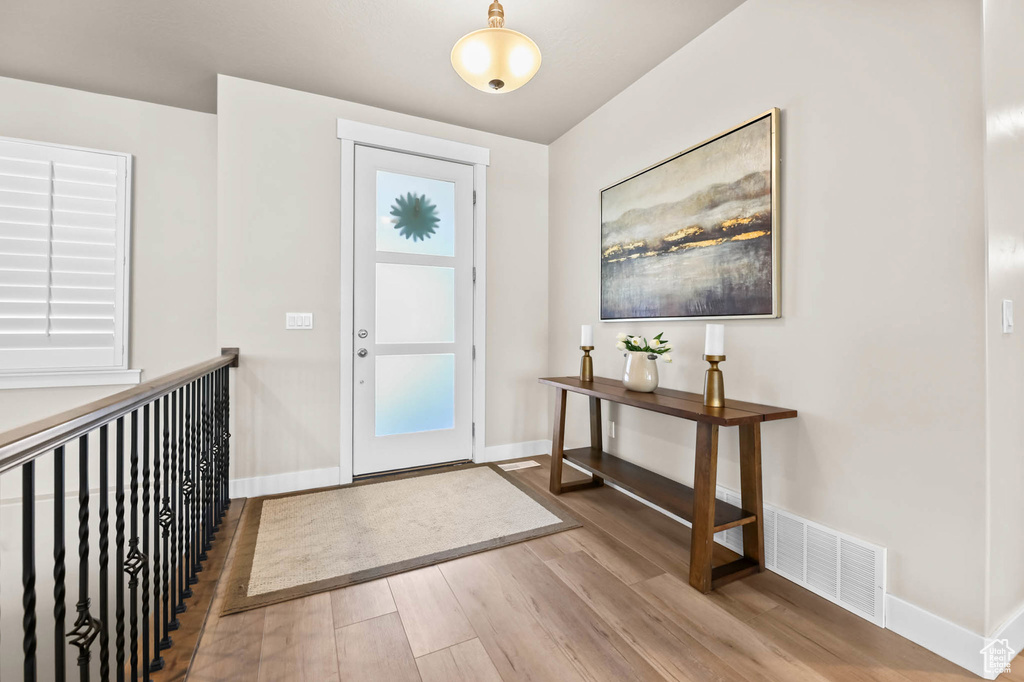Foyer entrance featuring wood finished floors and baseboards