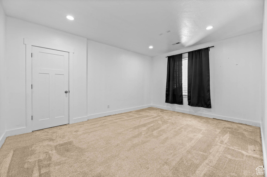 Spare room featuring carpet flooring, recessed lighting, and baseboards