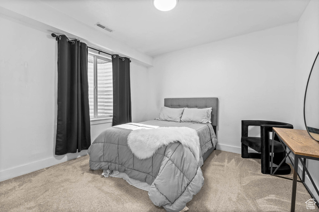 Carpeted bedroom featuring baseboards