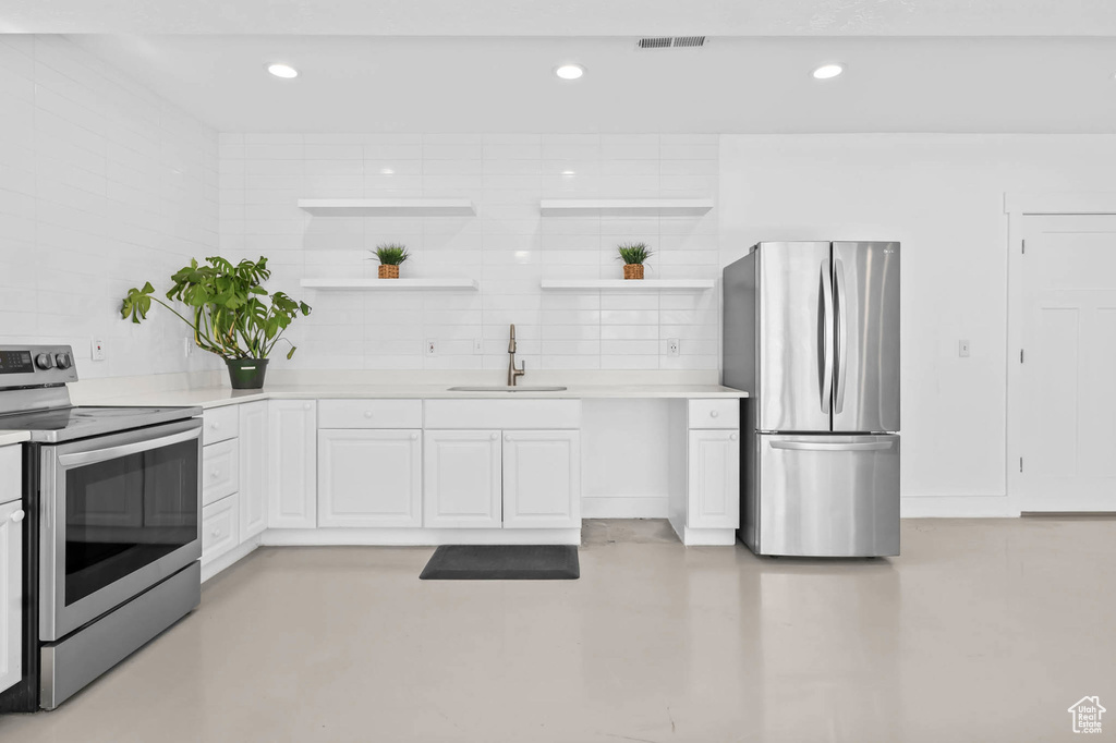 Kitchen featuring stainless steel appliances, a sink, white cabinetry, open shelves, and recessed lighting