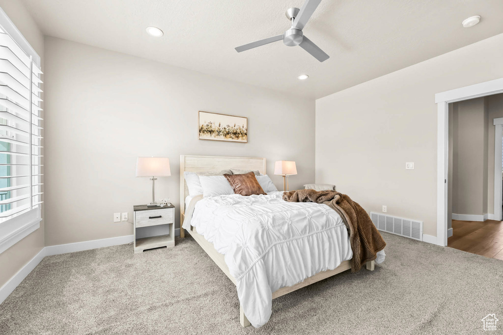 Bedroom featuring carpet floors, multiple windows, recessed lighting, baseboards, and ceiling fan