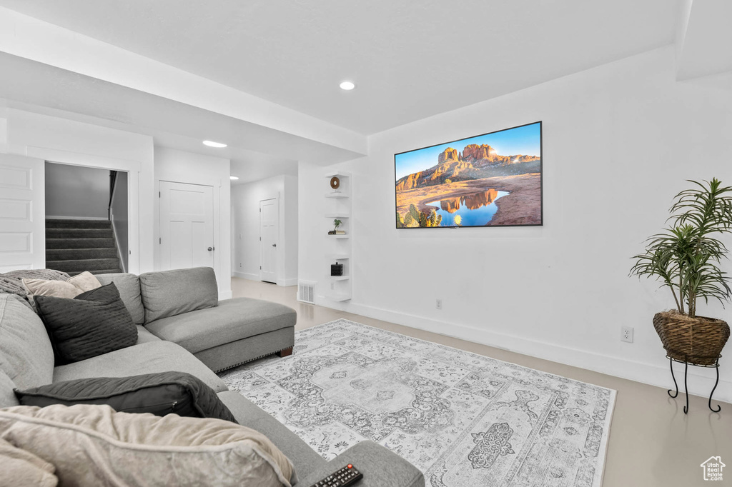 Living area featuring stairway, baseboards, recessed lighting, and built in features