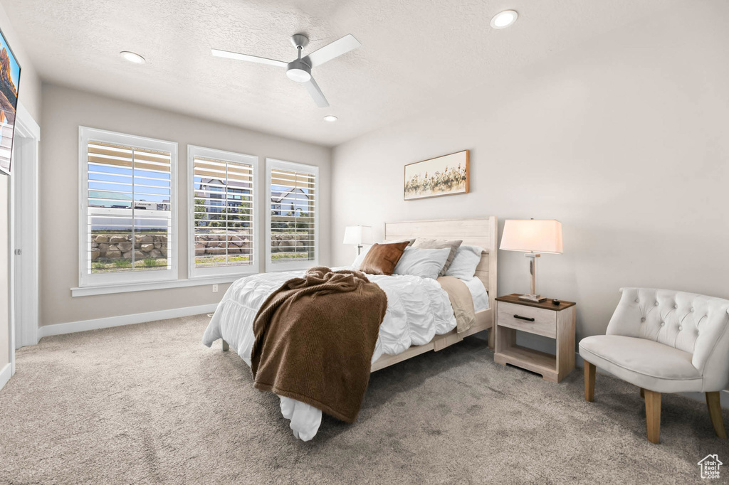 Bedroom featuring carpet, baseboards, recessed lighting, a textured ceiling, and ceiling fan