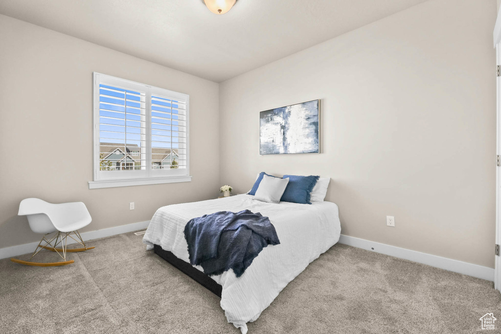 Bedroom featuring baseboards and carpet