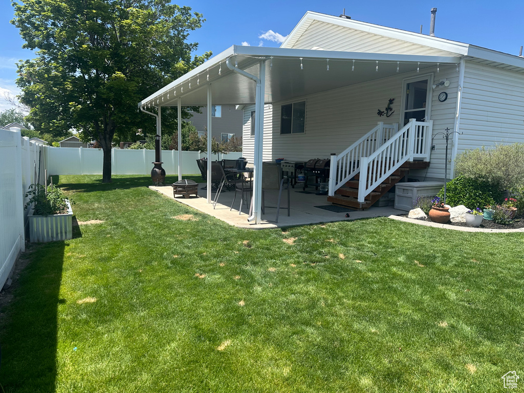 Back of house featuring a fire pit