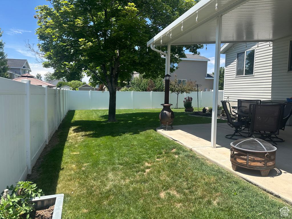 View of yard featuring a patio area and a fire pit