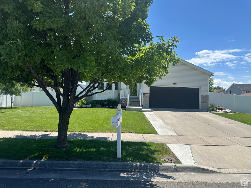 Obstructed view of property with concrete driveway and an attached garage