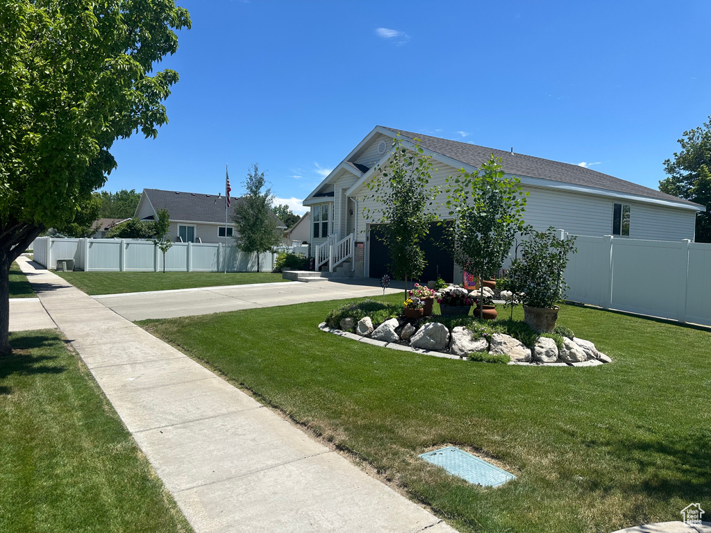 View of yard featuring concrete driveway