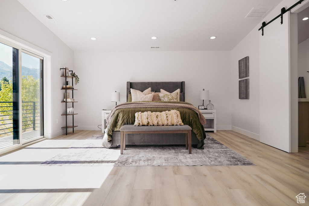 Bedroom featuring a barn door, light wood-style flooring, access to outside, recessed lighting, and baseboards