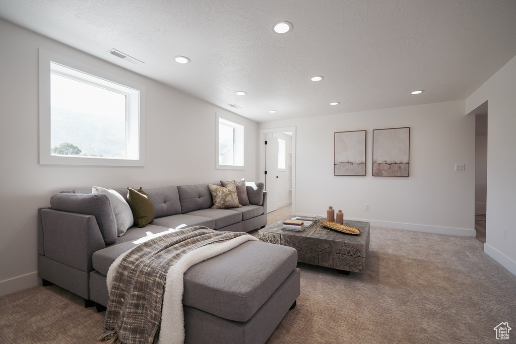 Living area with recessed lighting, carpet floors, and baseboards