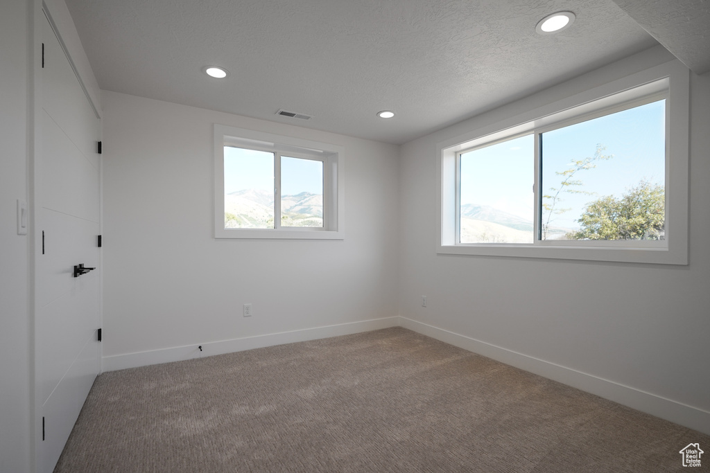 Unfurnished room featuring carpet flooring, recessed lighting, and baseboards