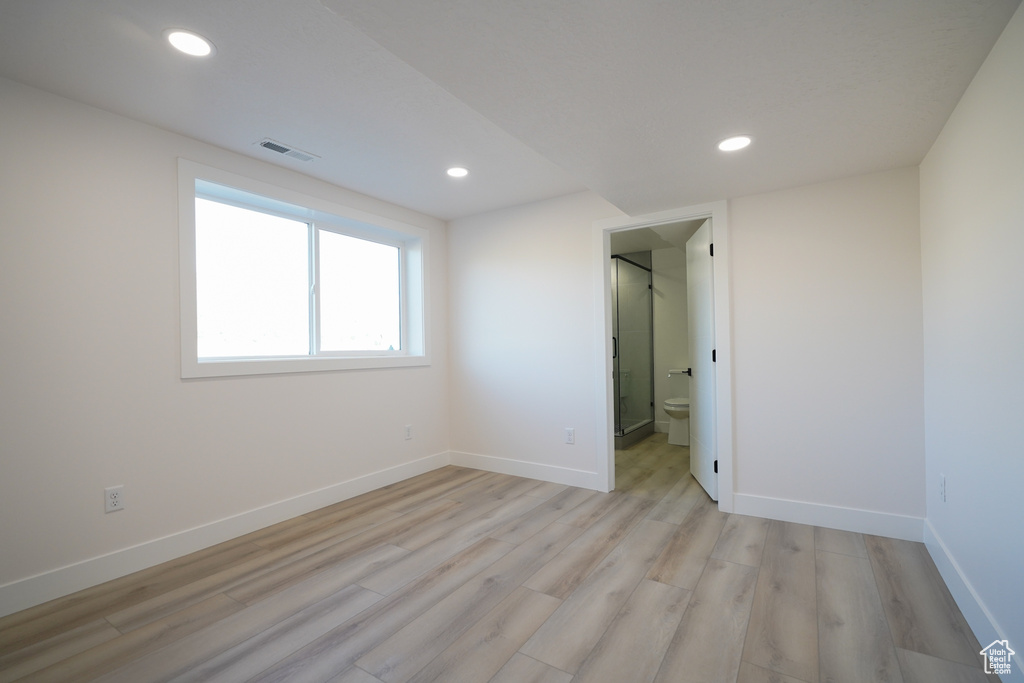 Unfurnished bedroom with light wood-style floors, recessed lighting, and baseboards