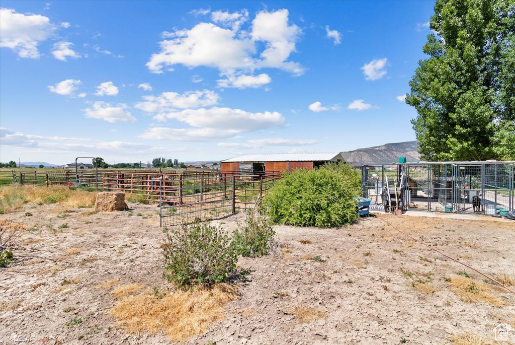 View of yard with an outbuilding and a view of rural / pastoral area